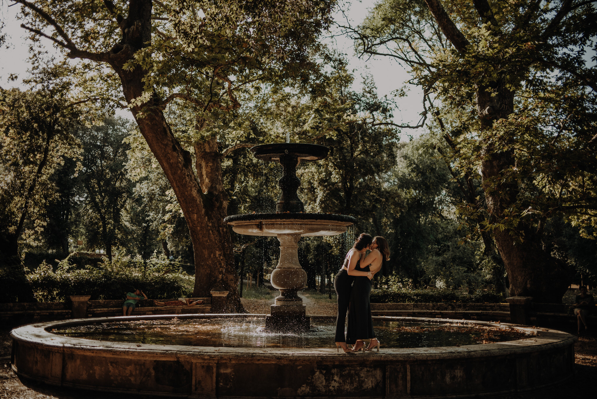 Surprise proposal and engagement celebration in the lush garden of Villa Borghese